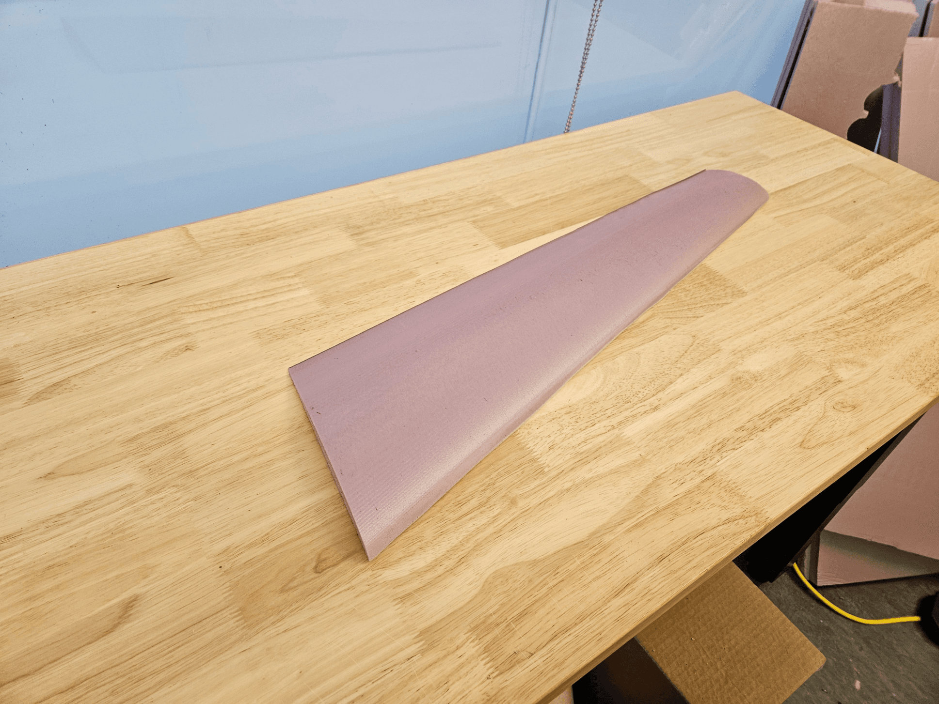 Cut foam airfoil section on a workbench