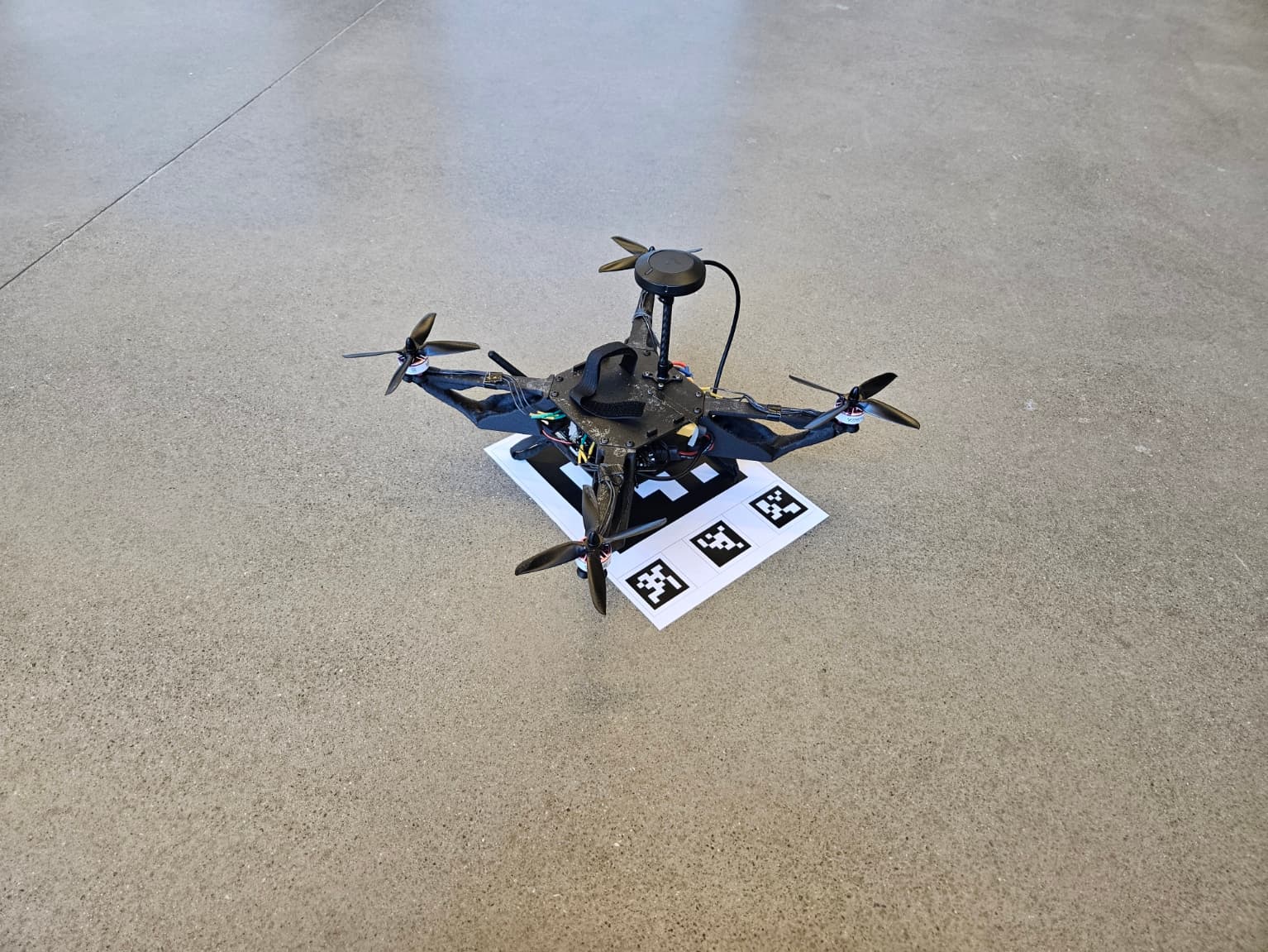Drone sitting on an ArUco landing target during a vision test